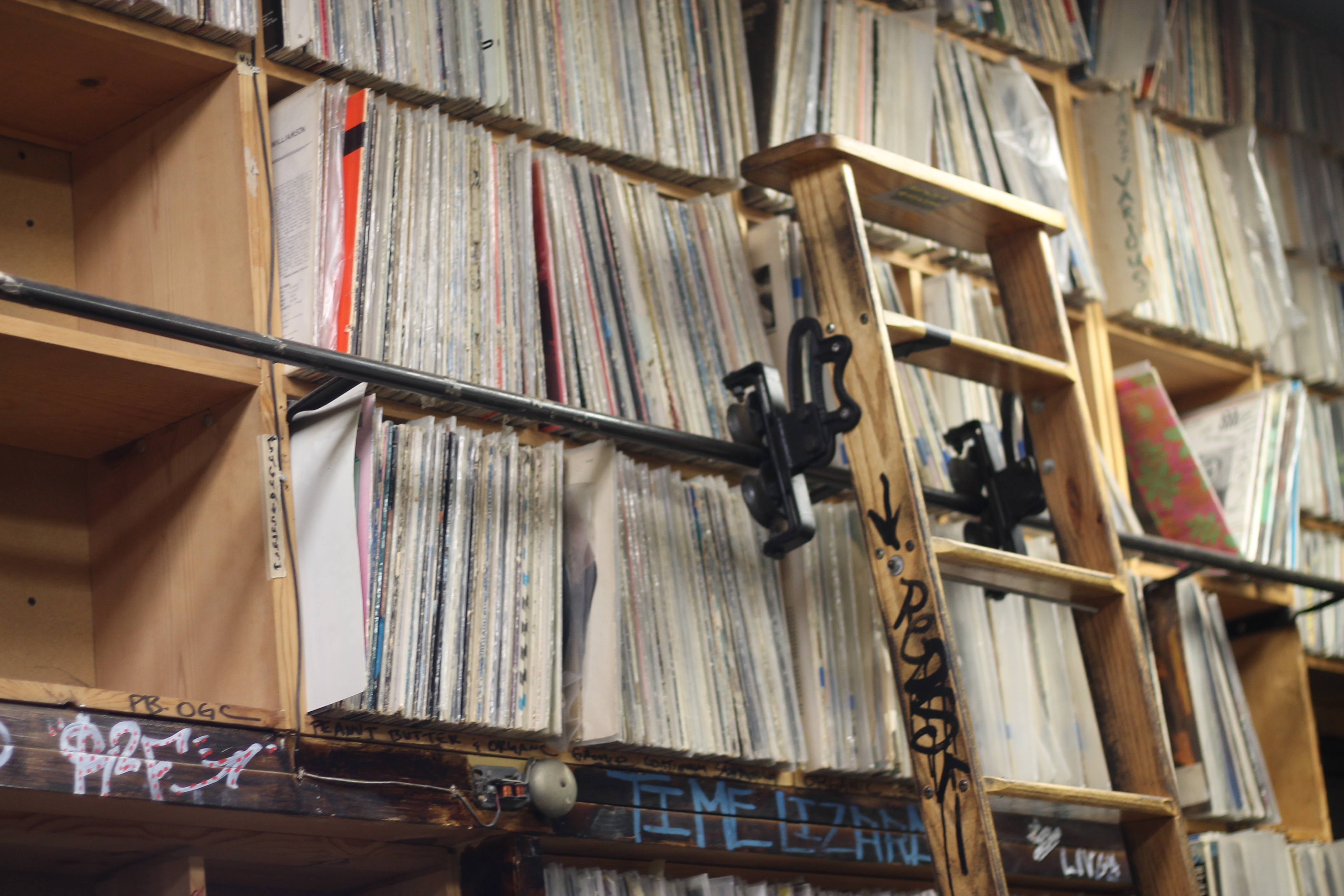 image of a wall of records and a ladder